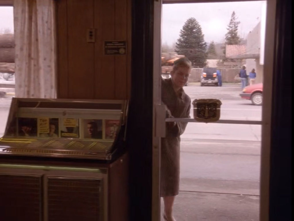 Heidi entering the front door of the diner