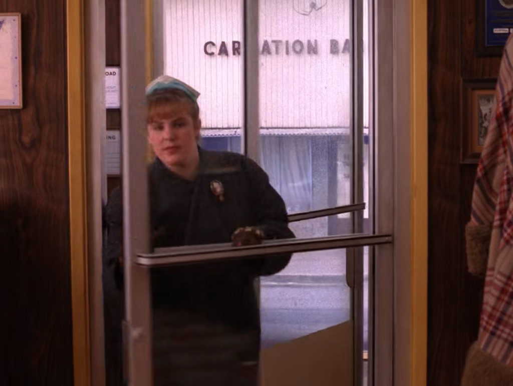 Heidi entering the front doors of the Double R Diner