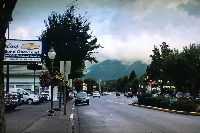 Establishing shot of road lined with businesses