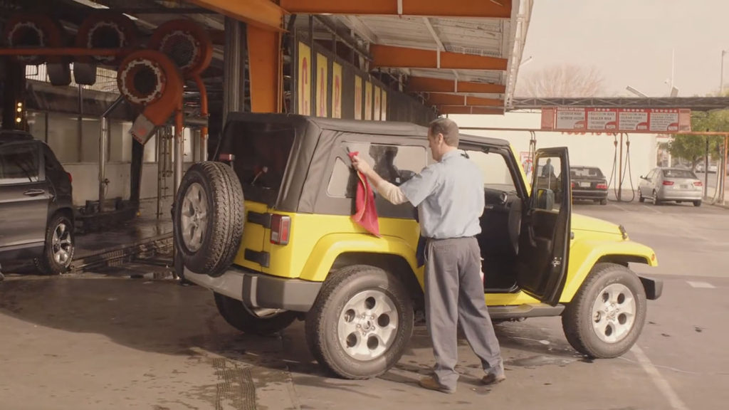 Jade's Yellow Jeep being washed at a car wash