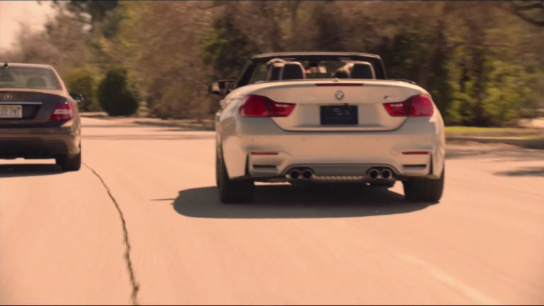 Cooper driving a BMW on the road