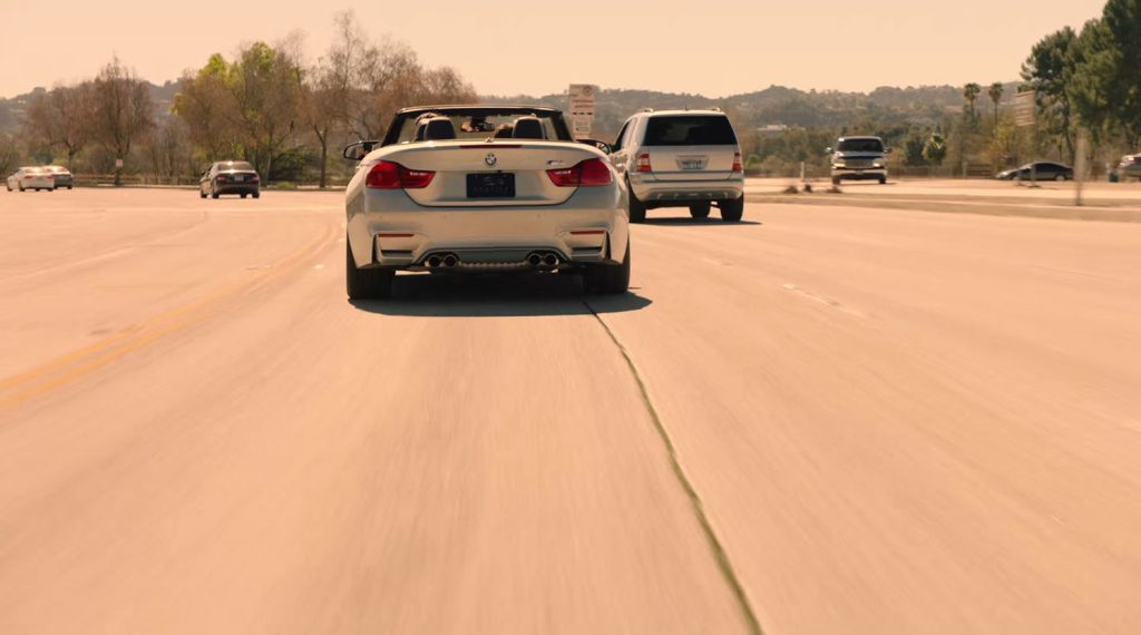 Back of BMW on a road with other cars