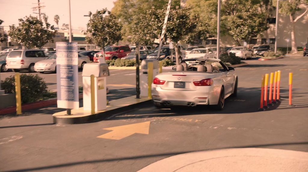 BMW passing through parking lot gate