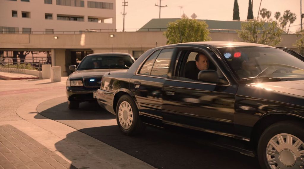 Two cars parked outside the hospital