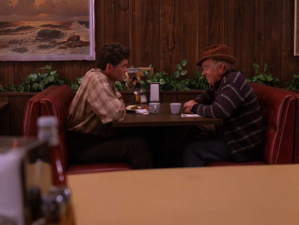 Big Ed Hurley and Dr. Hayward sit in a booth at the Double R Diner