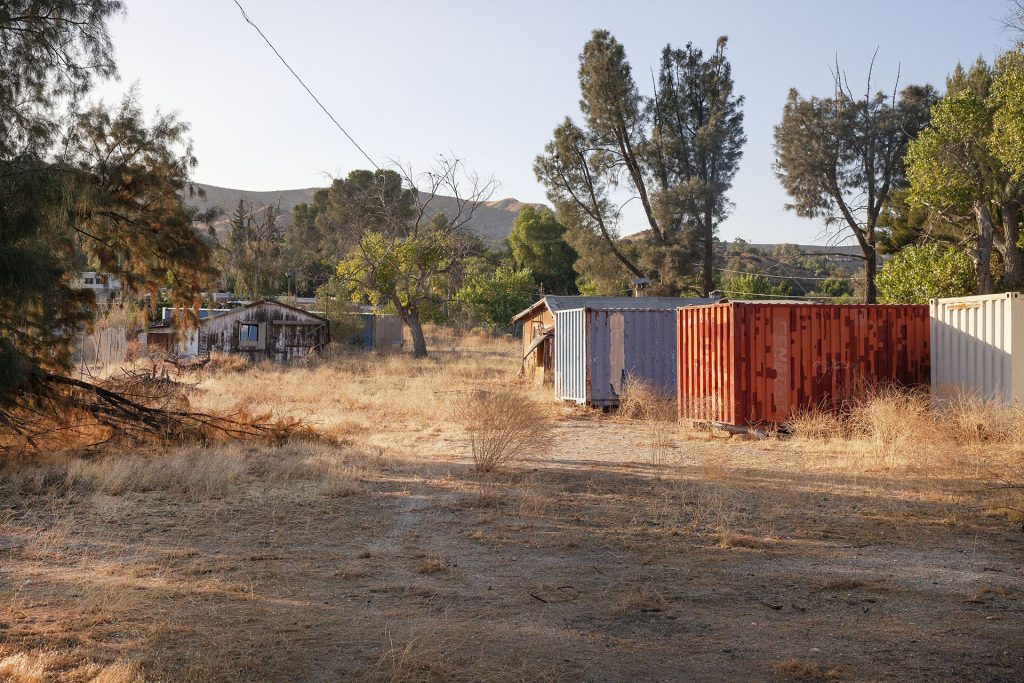 The zone with two containers and an old shack