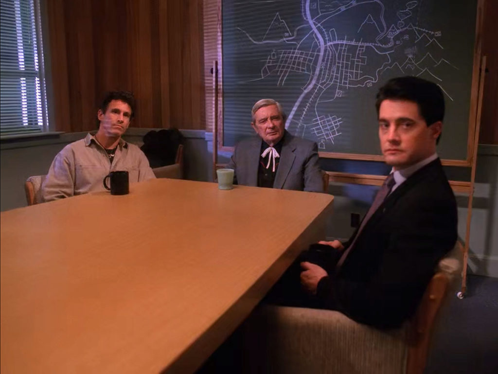 Sheriff Truman, Judge Sternwood and Agent Cooper sitting at the Twin Peaks Sheriff's Department Conference Room table