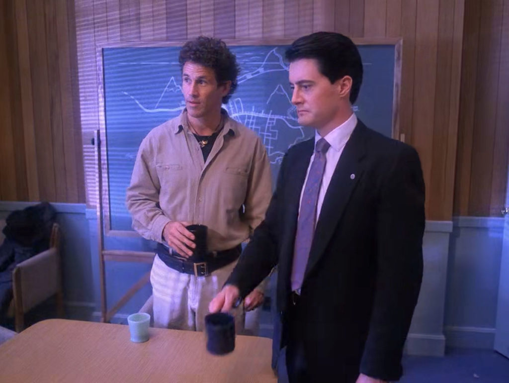 Sheriff Truman, Judge Sternwood and Agent Cooper sitting at the Twin Peaks Sheriff's Department Conference Room table