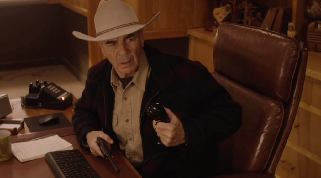 Sheriff Frank Truman sitting at his desk