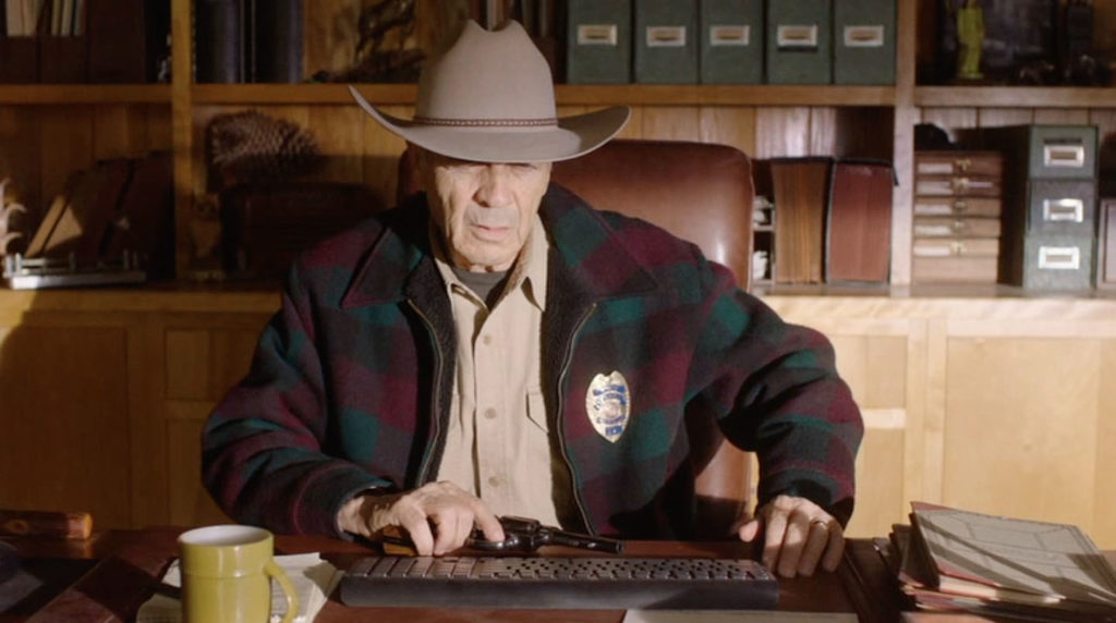 Sheriff Frank Truman sitting at his desk