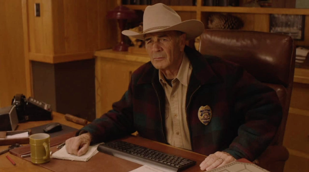 Sheriff Frank Truman sitting at his desk