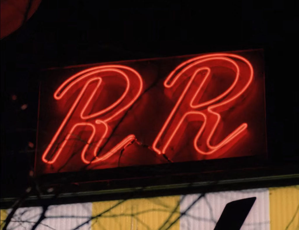 Neon "RR" sign at night