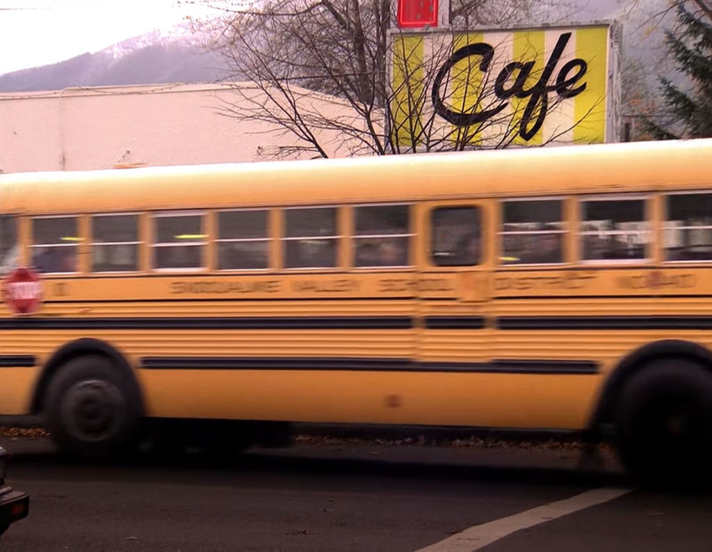 Yellow School bus passing by Double R Diner 