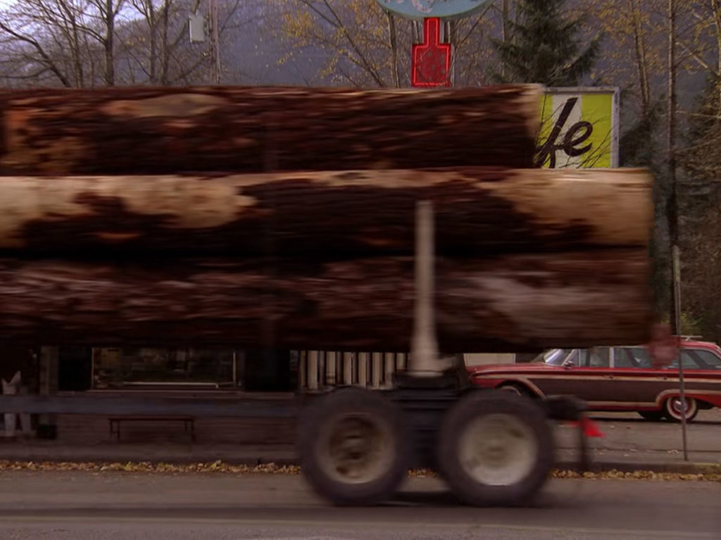 Logging truck passing Double R Diner