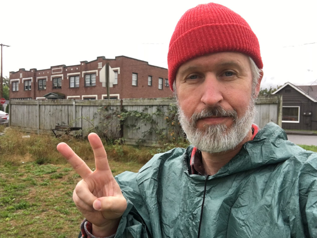 Steven Miller holding up two fingers at the former Riverside Mobile Home Park in Snoqualmie, Washington