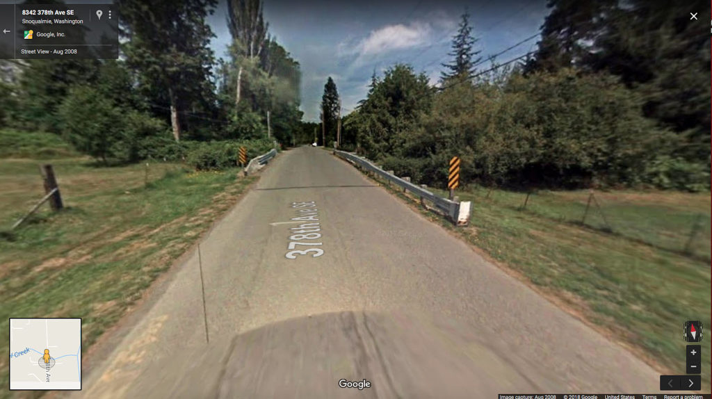 Road from Google Maps with a barrier along the side