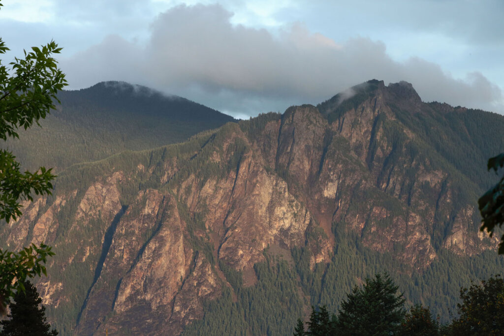 Mount Si against a cloud-filled sky at sunset