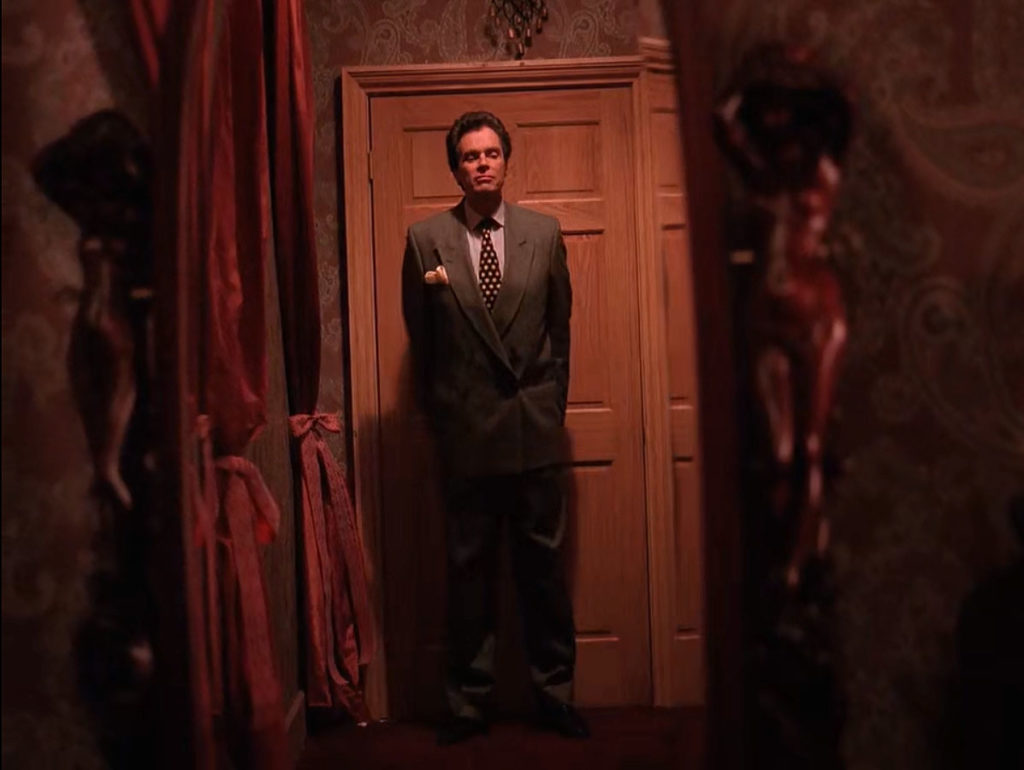 Ben Horne standing by a door