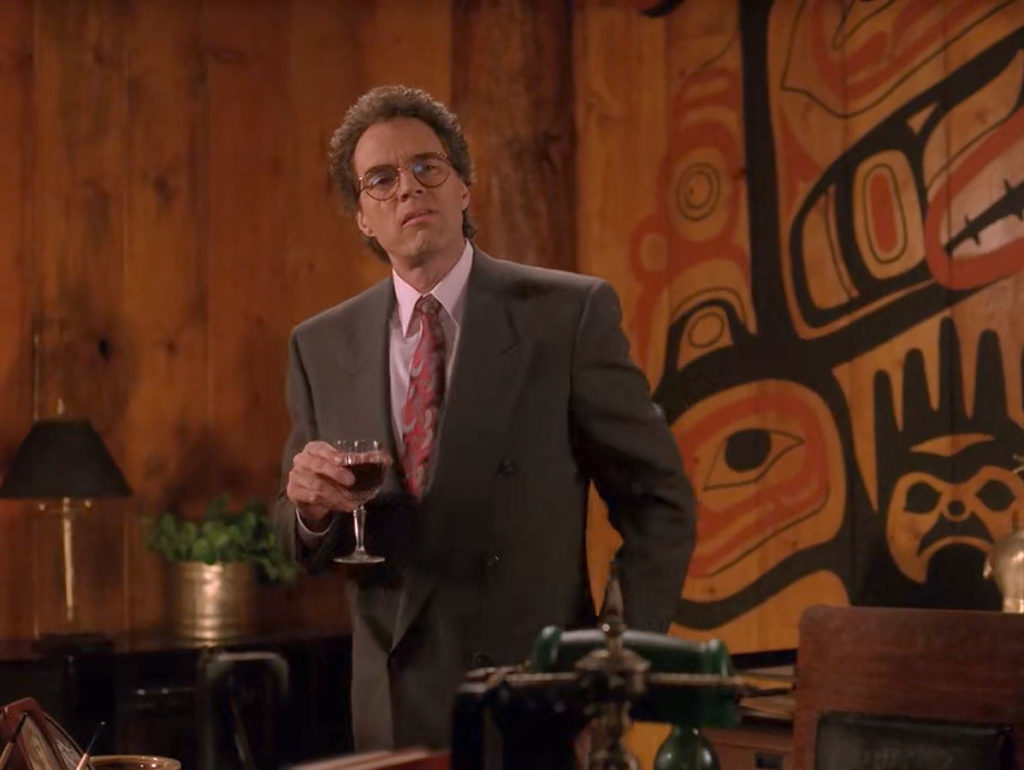 Ben Horne holding a wine glass in his office