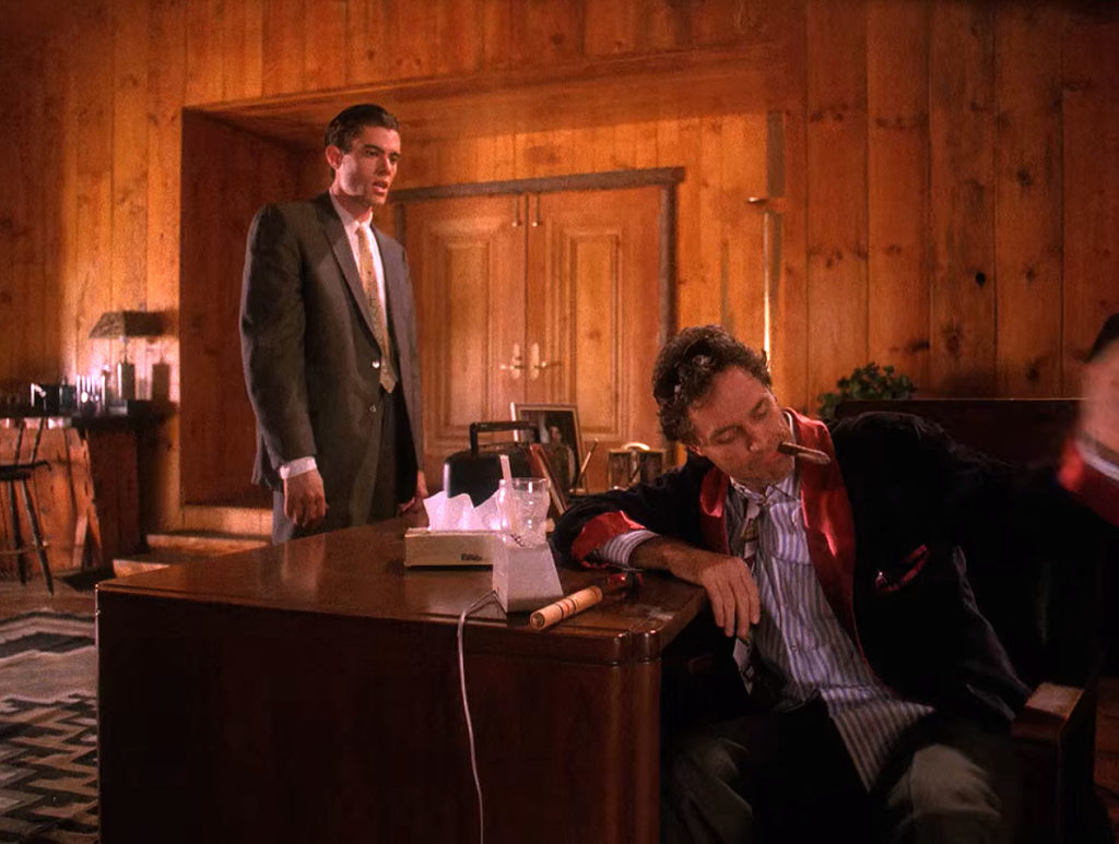 Bobby Briggs stands by Ben's desk as a disheveled Ben Horne sits in his chair