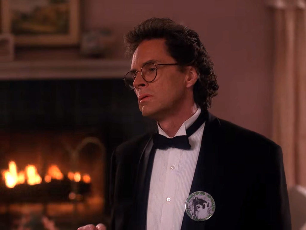 Ben Horne in a tuxedo by a fireplace