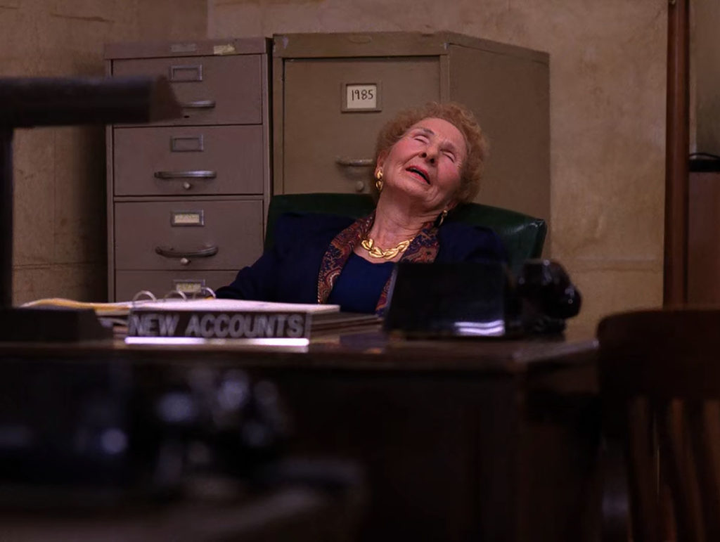 Bank worker sleeping at a desk