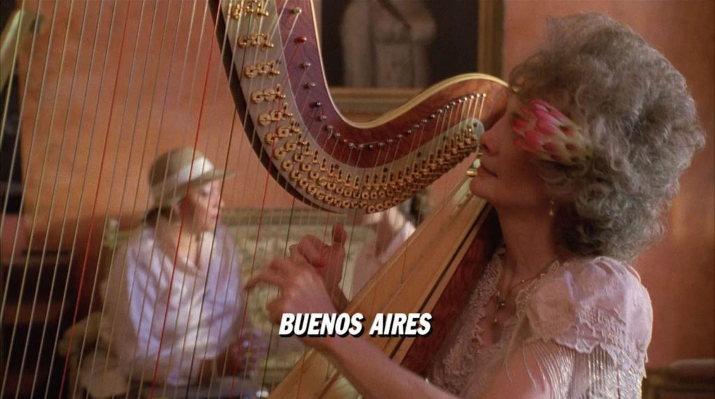 A lady playing a harp in the lobby of the Palm Deluxe Hotel in Twin Peaks - Fire Walk With Me with the subtitle "Buenos Aires" 