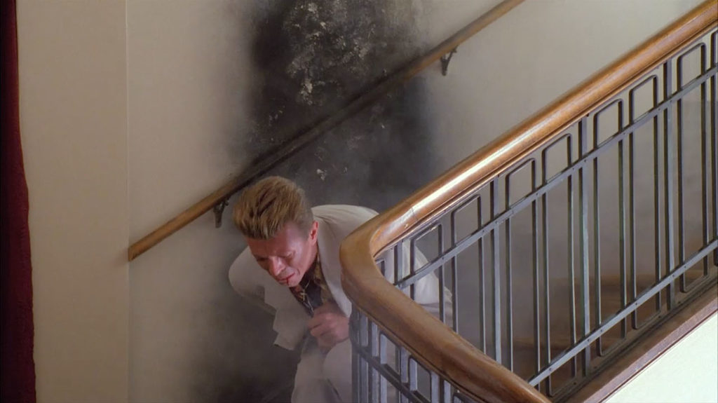 David Bowie as Agent Phillip Jeffries on stairs in anguish in Twin Peaks - Fire Walk With Me.
