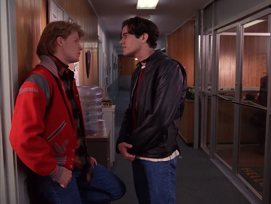 Mike Nelson and Bobby Briggs speak by a water cooler in the Twin Peaks Sheriff's Station