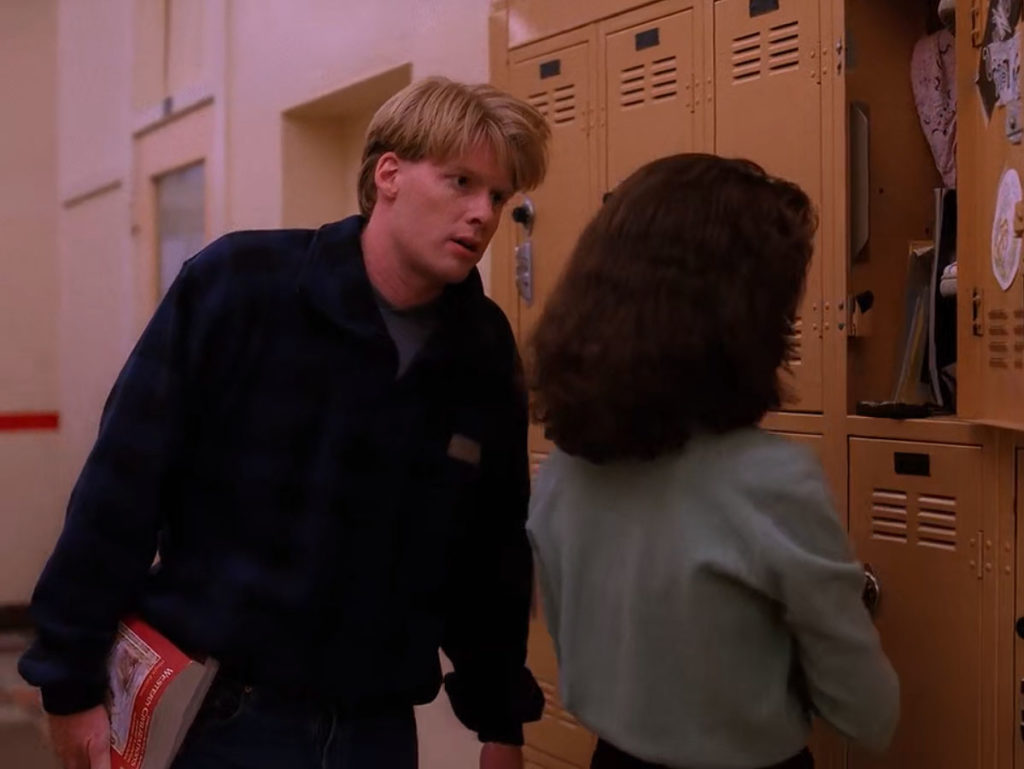 Mike Nelson speaking with Donna Hayward by yellow lockers