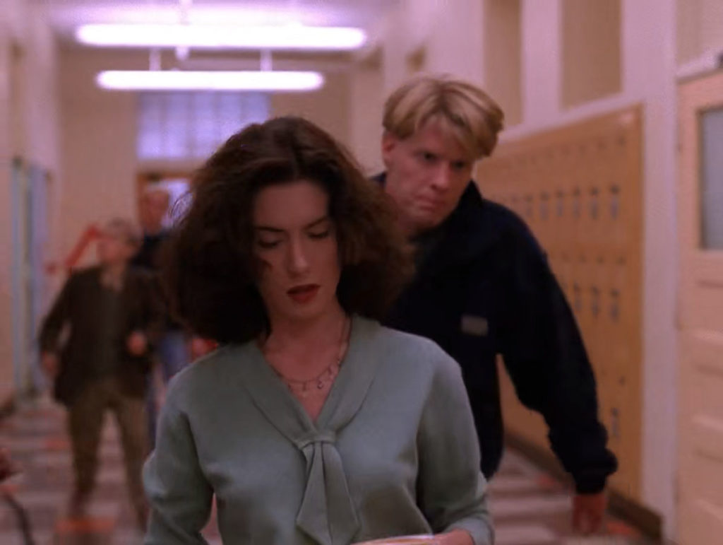 Mike Nelson following Donna Hayward in a hallway