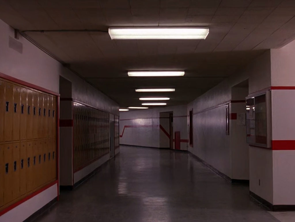 Hallway of Twin Peaks High School with yellow lockers and red stripes on wall