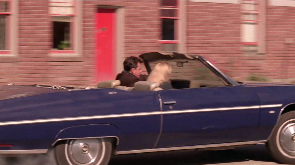 Leland and Laura Palmer pulling away in a blue car