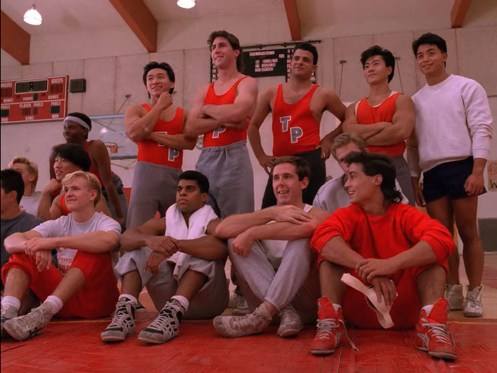 Wrestling Team standing and sitting in the gym