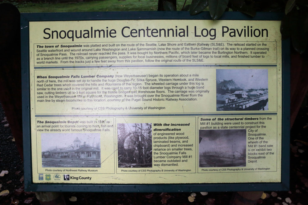 Snoqualmie Centennial Log Pavilion display containing historical images and text about the attraction