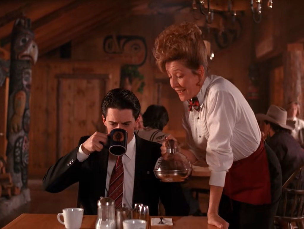 Trudy serving Special Agent Dale Cooper who is drinking coffee in The Great Northern Hotel dining room