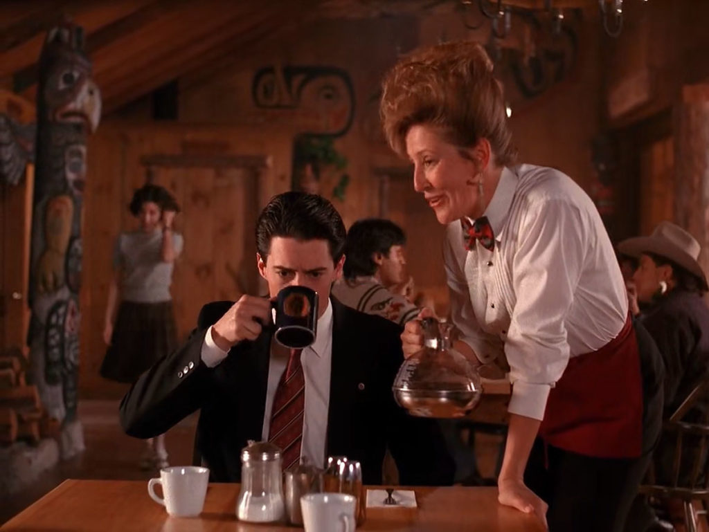 Trudy serving Special Agent Dale Cooper who is drinking coffee in The Great Northern Hotel dining room