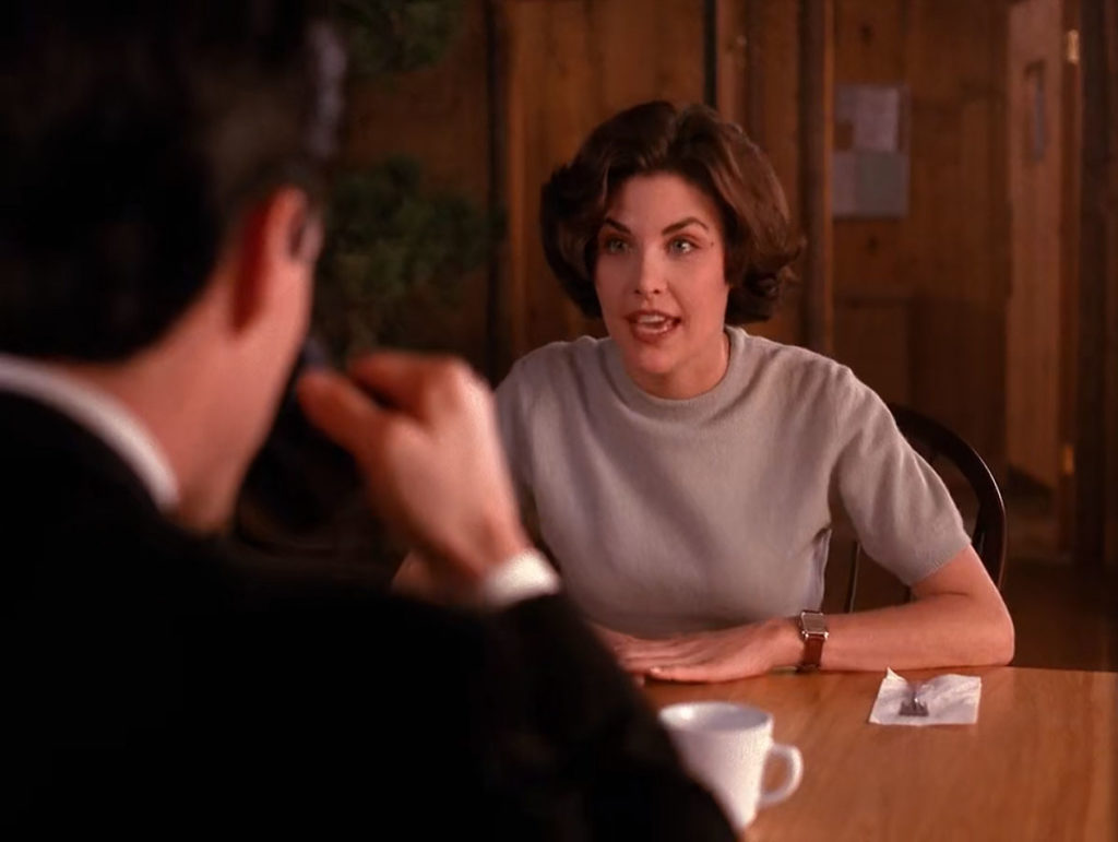 Audrey Horne speaking Special Agent Dale Cooper who is drinking coffee in The Great Northern Hotel dining room