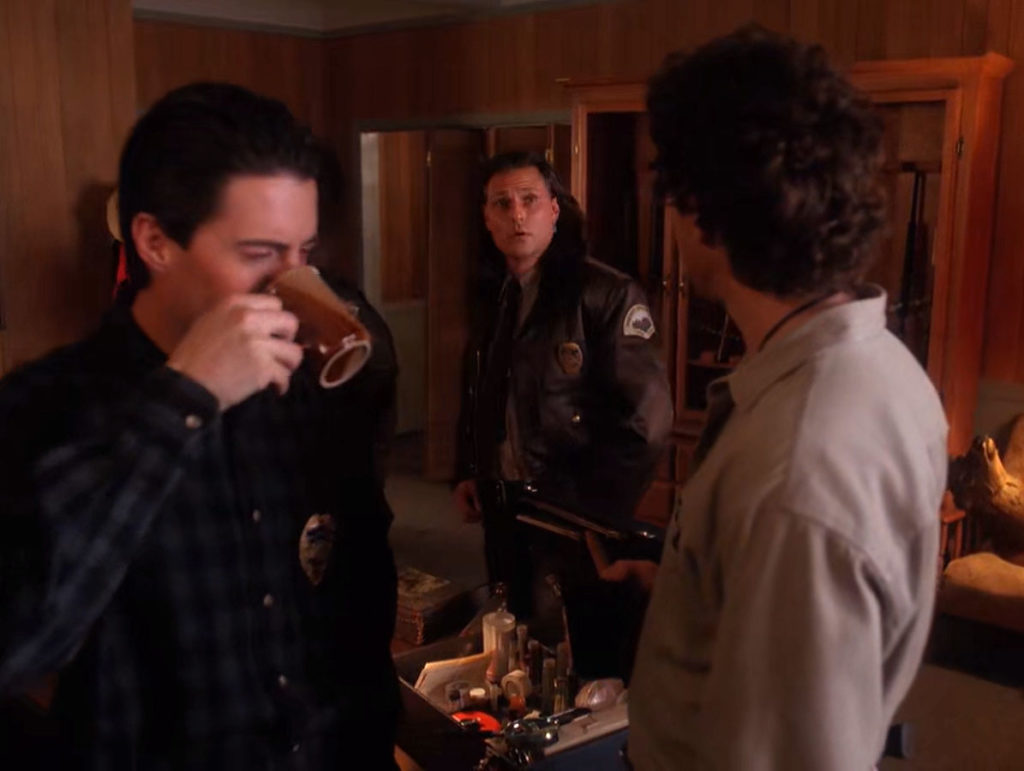 Sheriff Truman and Deputy Dale Cooper drinking coffee as Deputy Hawk leaves the office