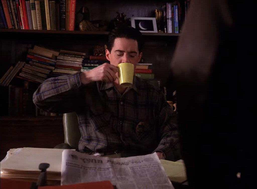 Deputy Dale Cooper drinking coffee at Sheriff Truman's desk