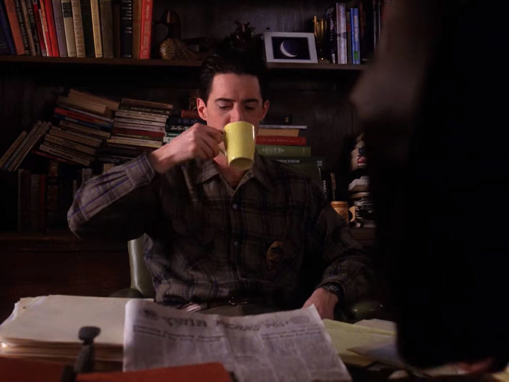 Deputy Dale Cooper drinking coffee at Sheriff Truman's desk