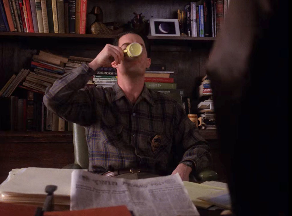 Deputy Dale Cooper drinking coffee at Sheriff Truman's desk