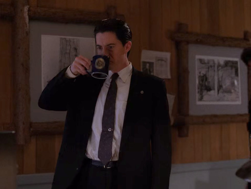 Cooper drinks coffee in the conference room at the Twin Peaks Sheriff's Department