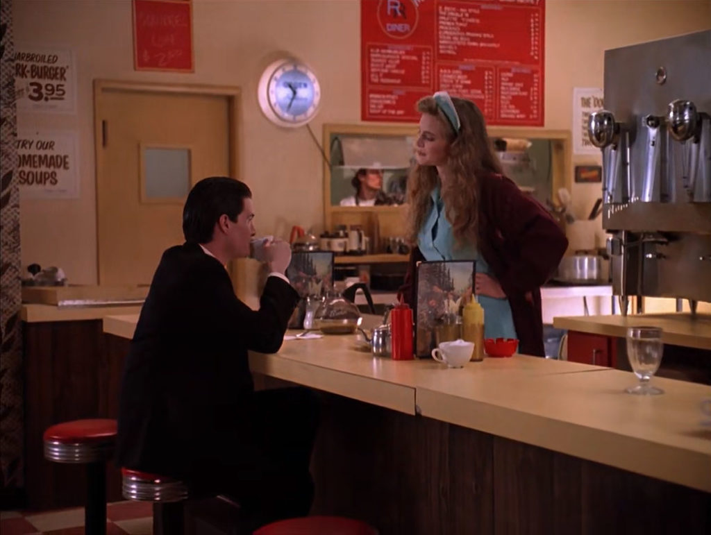 Special Agent Dale Cooper drinks coffee at The Double R Diner while speaking with Annie Blackburn