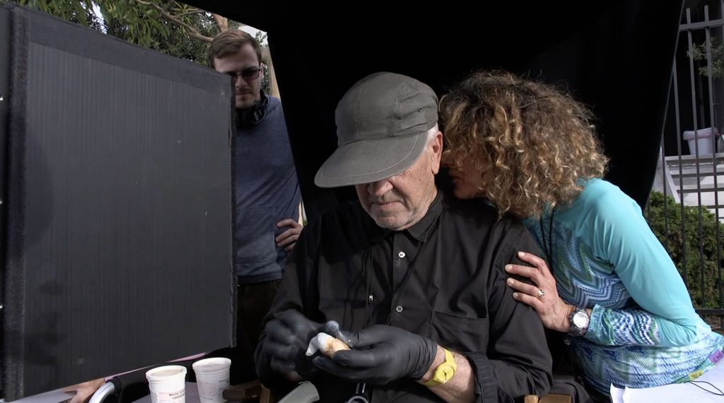 Cori Glazer whispering something to David Lynch