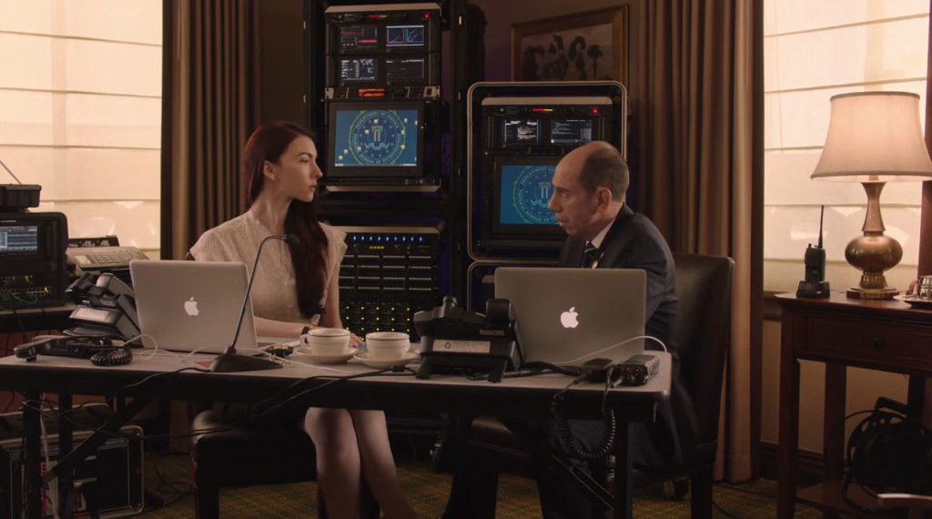 Agents Present and Rosenfield sitting at a desk with MacBooks