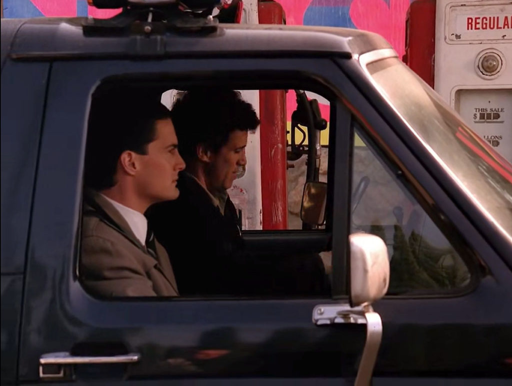 Agent Cooper and Sheriff Truman sitting in Ford Bronco at gas station