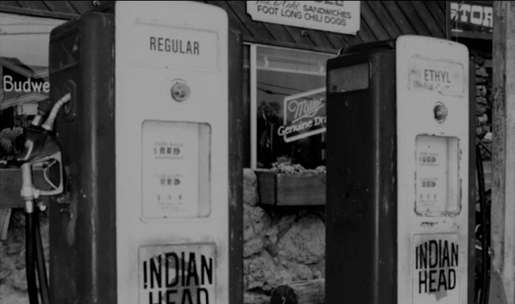 Black and white image of gas pumps