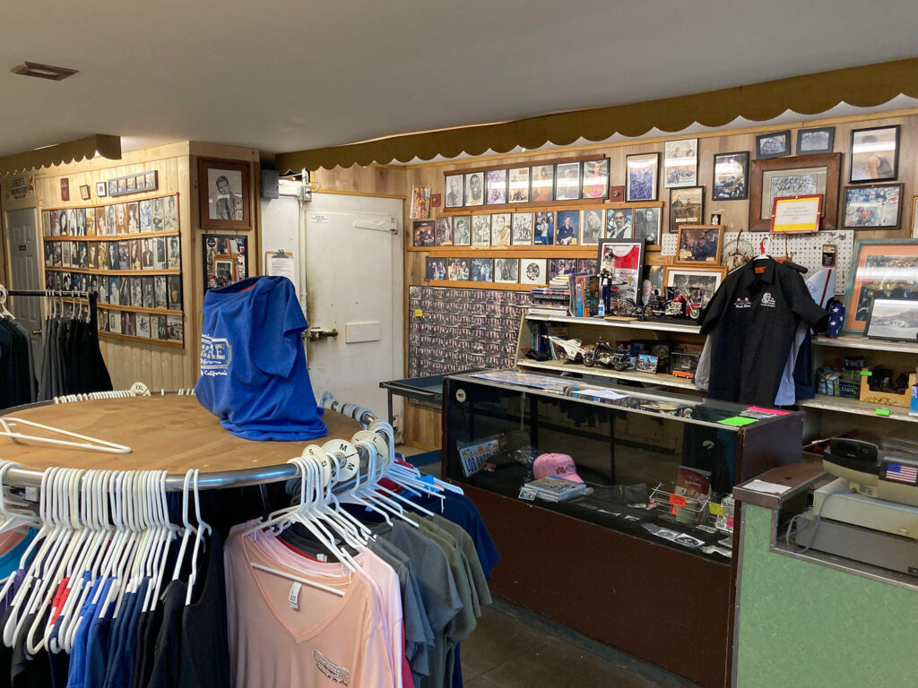 Inside of The Rock Store with merchandise racks and photos on the wall