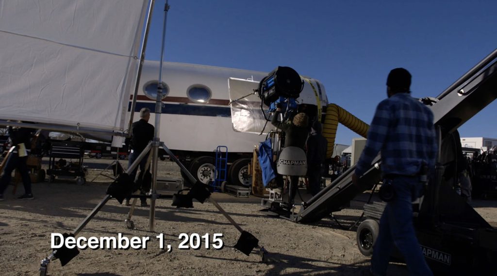 Film crew working on a mock up of a jet